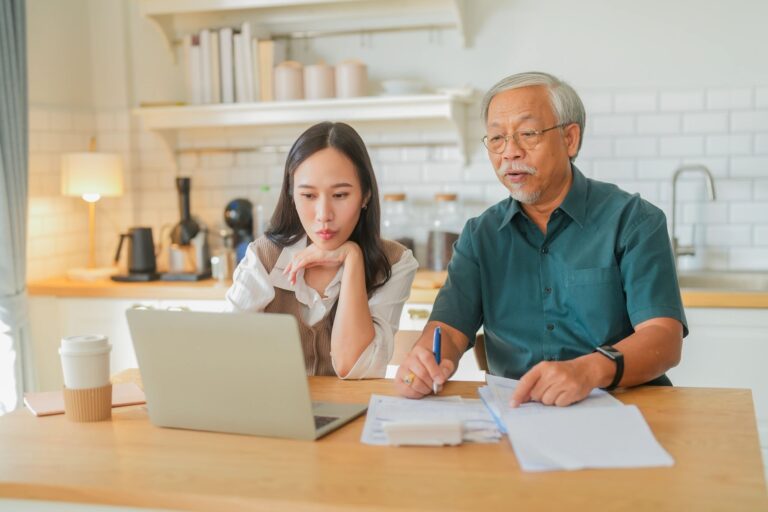 Two people working together at kitchen table